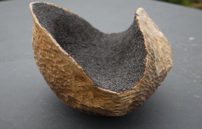 carved wooden sculpture with magnetite